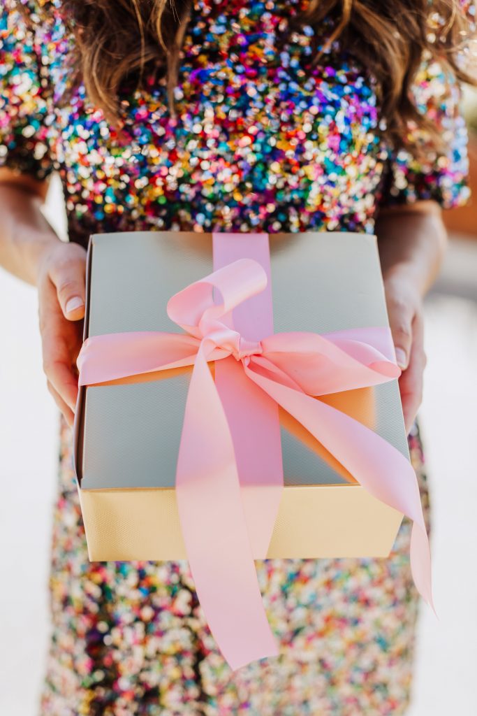 Gold box wrapped in a pink bow | Lifestyled By Sofia Holiday Gift Guide