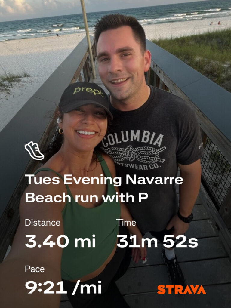 Strava run data overlaid on a selfie of a couple on a beach access bridge taken after a run