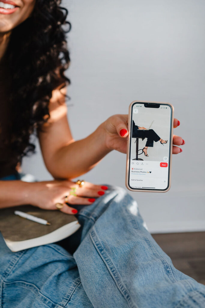 Close up of a woman holding a cellphone showing a Pinterest small business branding inspiration photo